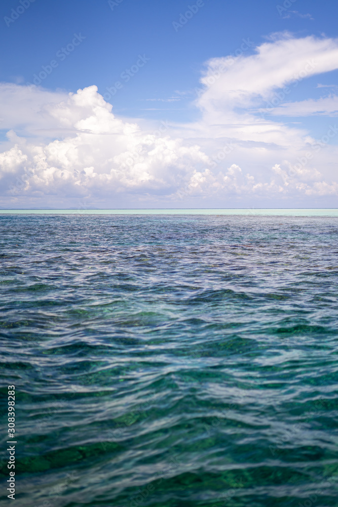 Fototapeta premium Three tones of sea under a beutiful sky. Dark blue and turquoise green in Semporna Islands, Borneo, Sabah.