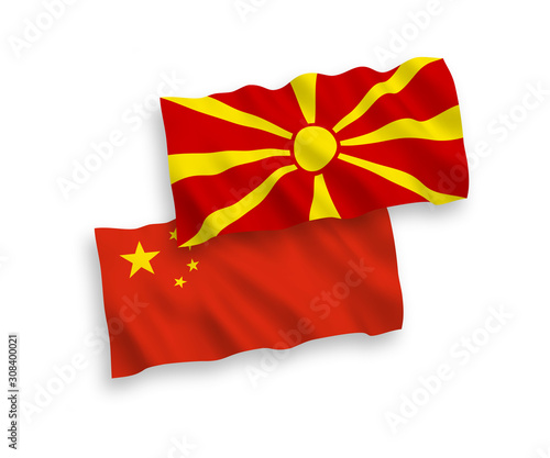 National vector fabric wave flags of North Macedonia and China isolated on white background 1 to 2 proportion.