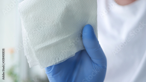 Close Up Man Hands with Blue Gloves Cleaning a Window