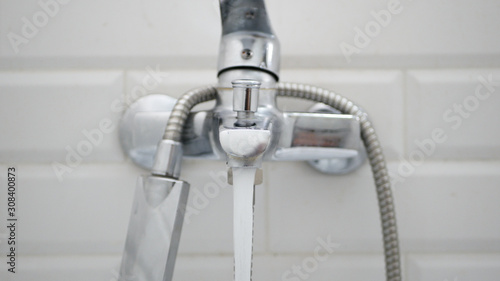 Man in Apartment Bathroom Opening and Closing Water Faucet
