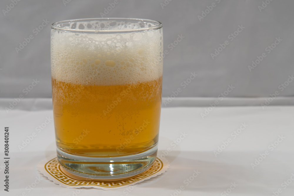 IPA with foam isolated, white background. Fresh india pale ale beer with head in clear glass. IPA with foam isolated, white background. Fresh india pale ale beer with head in clear glass.