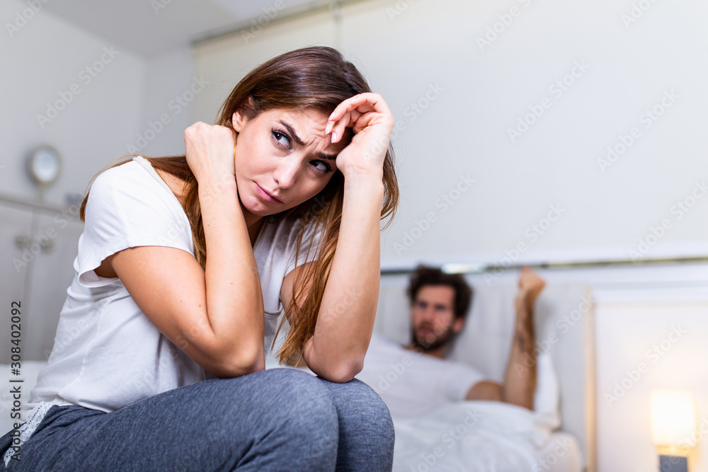 Frustrated sad girlfriend sit on bed think of relationship problems, thoughtful couple after quarrel lost in thoughts, upset lovers consider break up, offended person disappointed by boyfriend Frustrated sad girlfriend sit on bed think of relationship problems, thoughtful couple after quarrel lost in thoughts, upset lovers consider break up, offended person disappointed by boyfriend