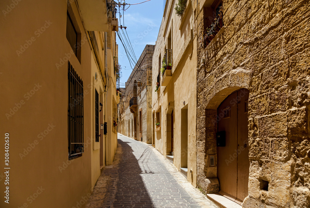 A narrow medieval street with stone stairs in an old European town