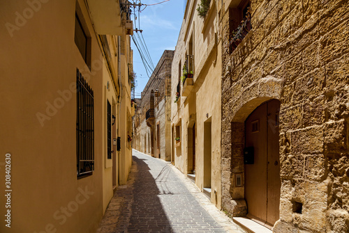 A narrow medieval street with stone stairs in an old European town