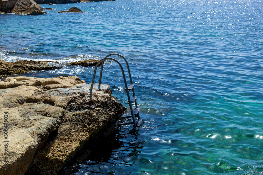 Fototapeta premium The metal ladder for the descent into the sea
