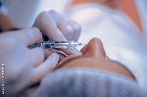 Blur, bokeh, background, abstract, image for background. Cosmetology medical operation by plastic surgeon