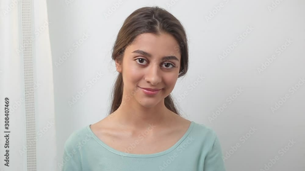 Portrait of a young Indian female student on a white background. Beautiful smiling brunette girl. Portrait of a young Indian female student on a white background. Beautiful smiling brunette girl.