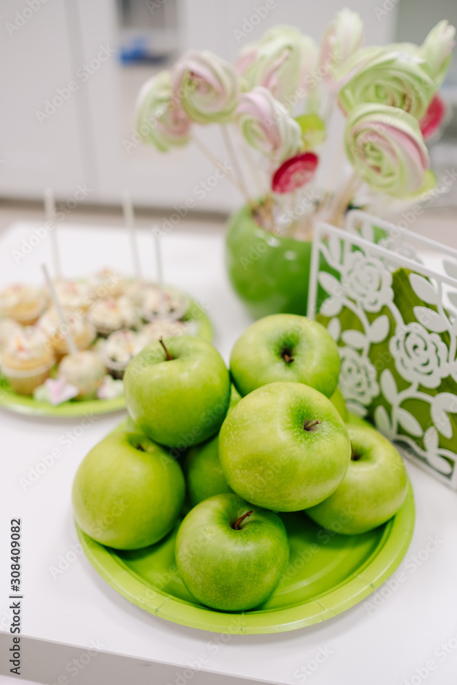 green apples and sweets on the table green apples and sweets on the table