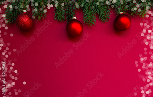 Christmas holidays composition on red background with copy space for your text. Christmas red decorations  fir tree branches on red background. Flat lay  top view  copy space.