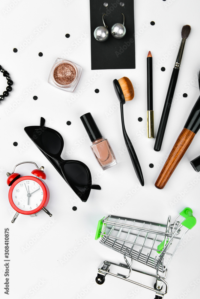 concept female shopping, flat lay. flatlay. Flat lay female accessories cosmetics, phone earphones alarm clock on a pink background. Valentine's Day March 8th. Top view of women's accessories. shoppin concept female shopping, flat lay. flatlay. Flat lay female accessories cosmetics, phone earphones alarm clock on a pink background. Valentine's Day March 8th. Top view of women's accessories. shoppin