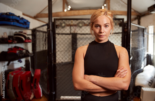 Portrait Of Female Mixed Martial Arts Fighter Training In Gym