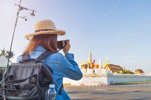 Photography Traveler Asian woman take a picture by her camera to Wat Phra Kaew