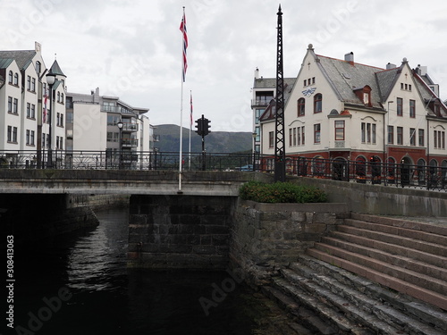 Bridge and secessionist houses in european Alesund town at square in Romsdal region in Norway