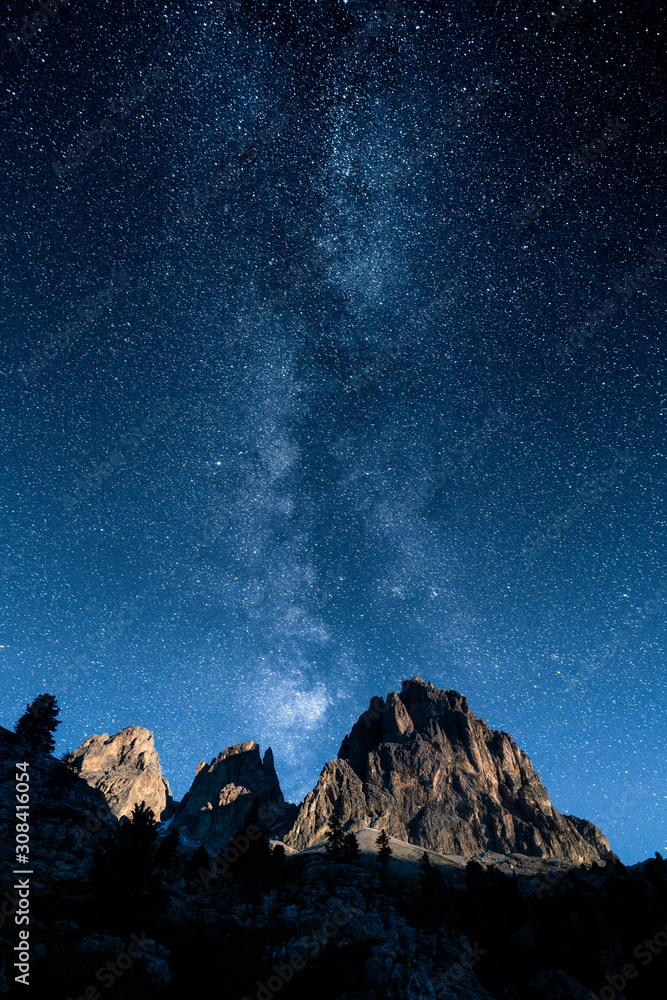 majestic mountain peaks and a beautiful milky way and stars on the sky.