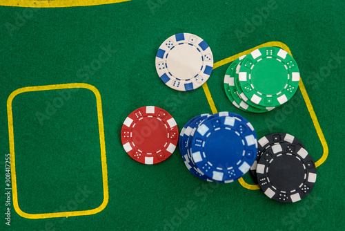 Colorful poker chips on green table. Gambling concept, background