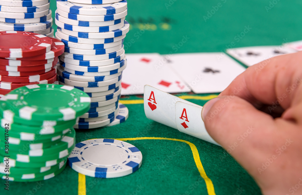 Winner combination. Human hand with playing cards and casino chips close up Winner combination. Human hand with playing cards and casino chips close up