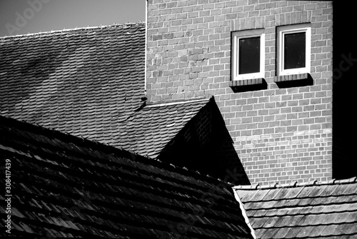 Ziegelbau mit Dachziegel und Sichtbares Mauerwerk mit 2 Fenstern in schwarz-weiß photo