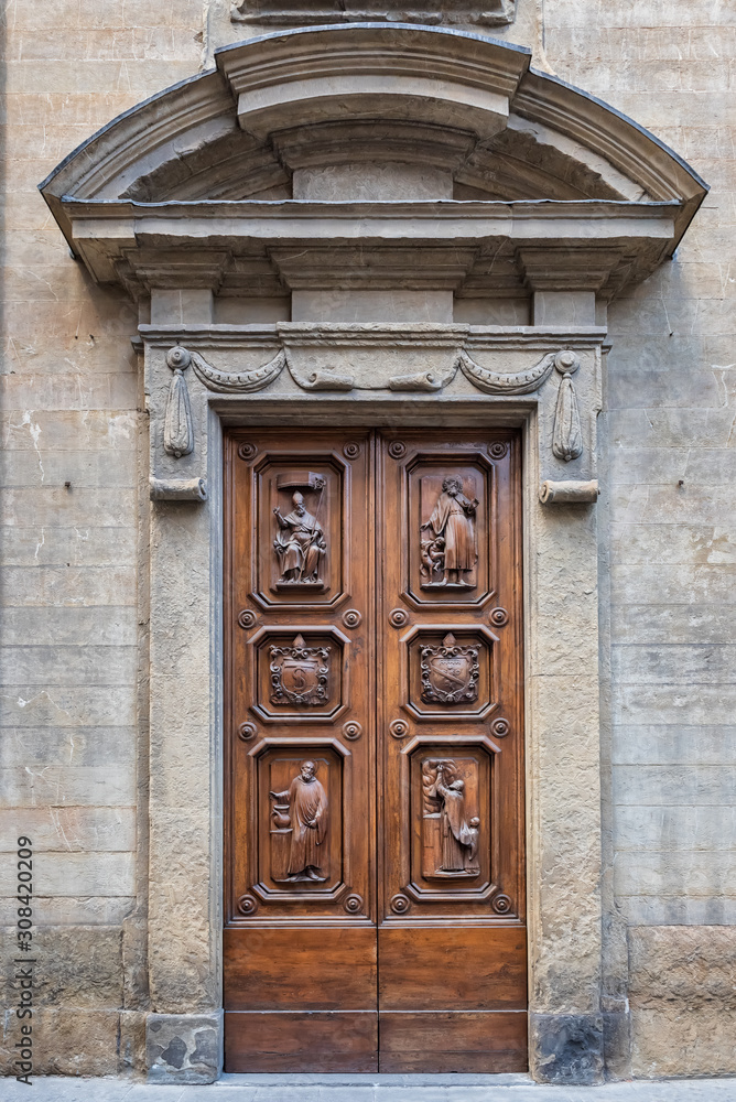 An old decorated vintage door in historical centre of Florence, Italy