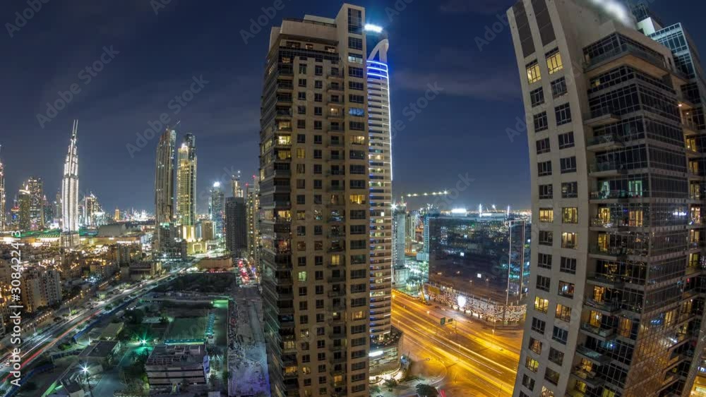 Beautiful skyline of Dubai downtown and Business bay with modern architecture night timelapse. Aerial view of Dubai illuminated skyscrapers from above with traffic on the road Beautiful skyline of Dubai downtown and Business bay with modern architecture night timelapse. Aerial view of Dubai illuminated skyscrapers from above with traffic on the road