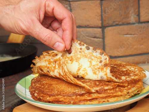 Pancakes are ready to eat. Making yeast pancakes (crepes). photo