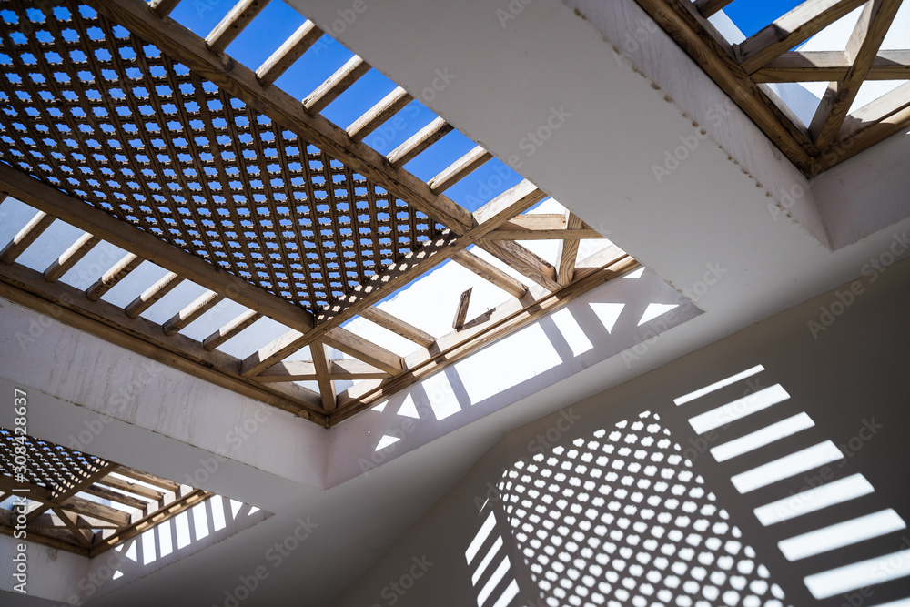 Wooden lattice and its Shadow on a wall. Distance. Wooden lattice and its Shadow on a wall. Distance.