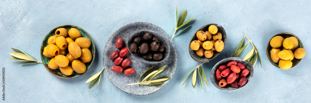 Olives flat lay panorama, top shot. Black, green and red olives of various sizes Olives flat lay panorama, top shot. Black, green and red olives of various sizes
