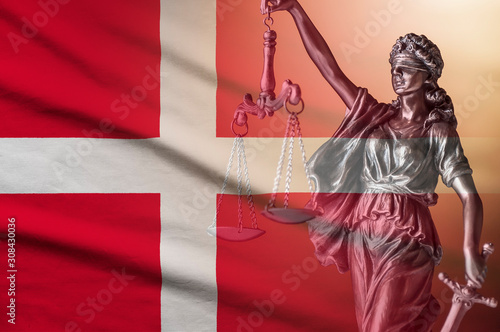 Figure of Justice holding scales on a Danish flag
