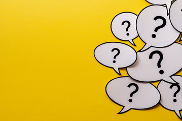 Multiple question marks in speech bubbles with copy space