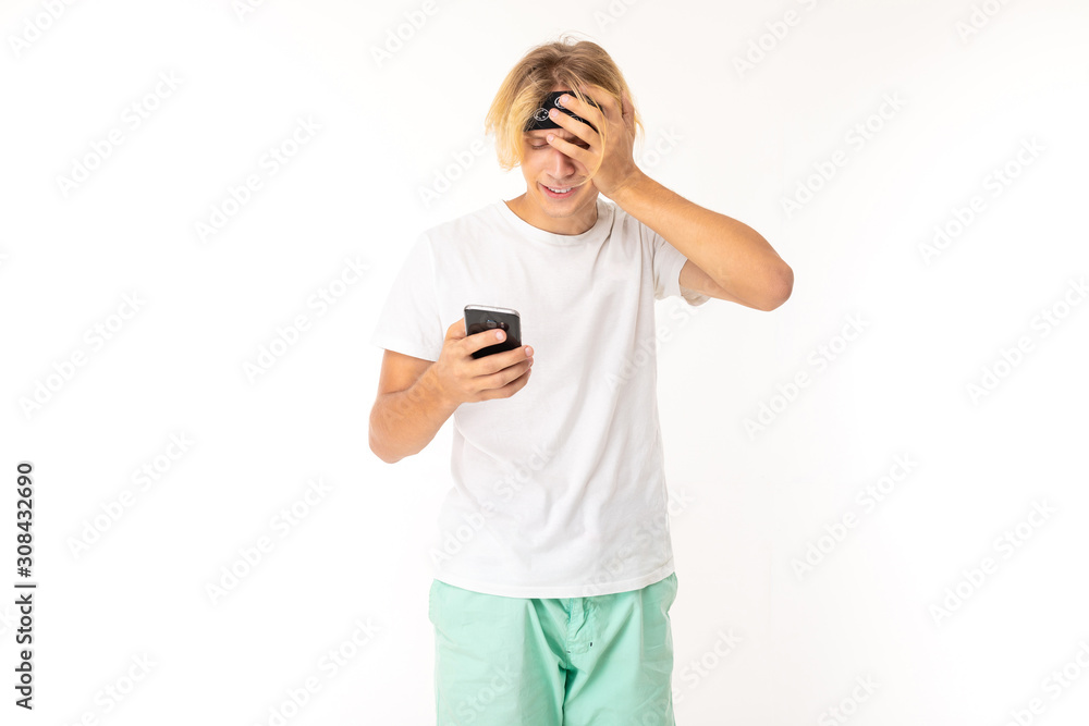 Stylish caucasian blonde man communicate with friends with his phone and has problems isolated on white background Stylish caucasian blonde man communicate with friends with his phone and has problems isolated on white background