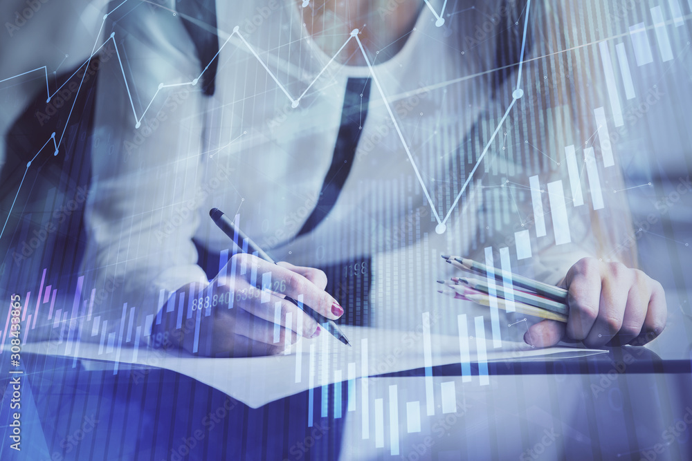 Double exposure of hands making notes with forex chart huds. Stock market concept. Double exposure of hands making notes with forex chart huds. Stock market concept.