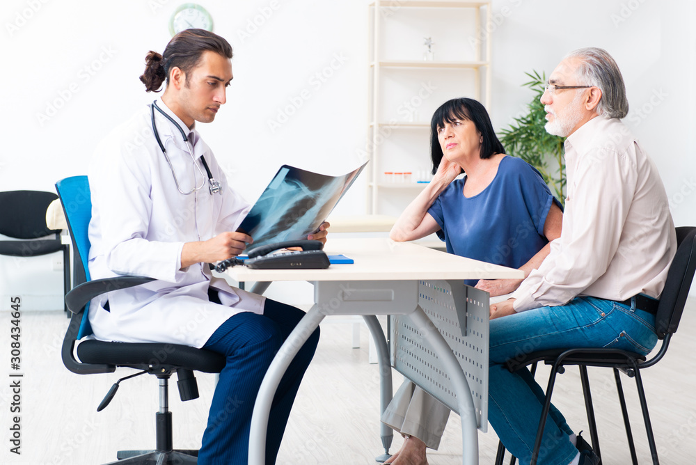 Old couple visiting young male doctor Old couple visiting young male doctor