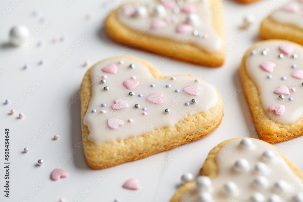 Flat lay of cookies hearts with icing and decorated for Valentine's Day, white background. Valentine's day concept. Flat lay of cookies hearts with icing and decorated for Valentine's Day, white background. Valentine's day concept.