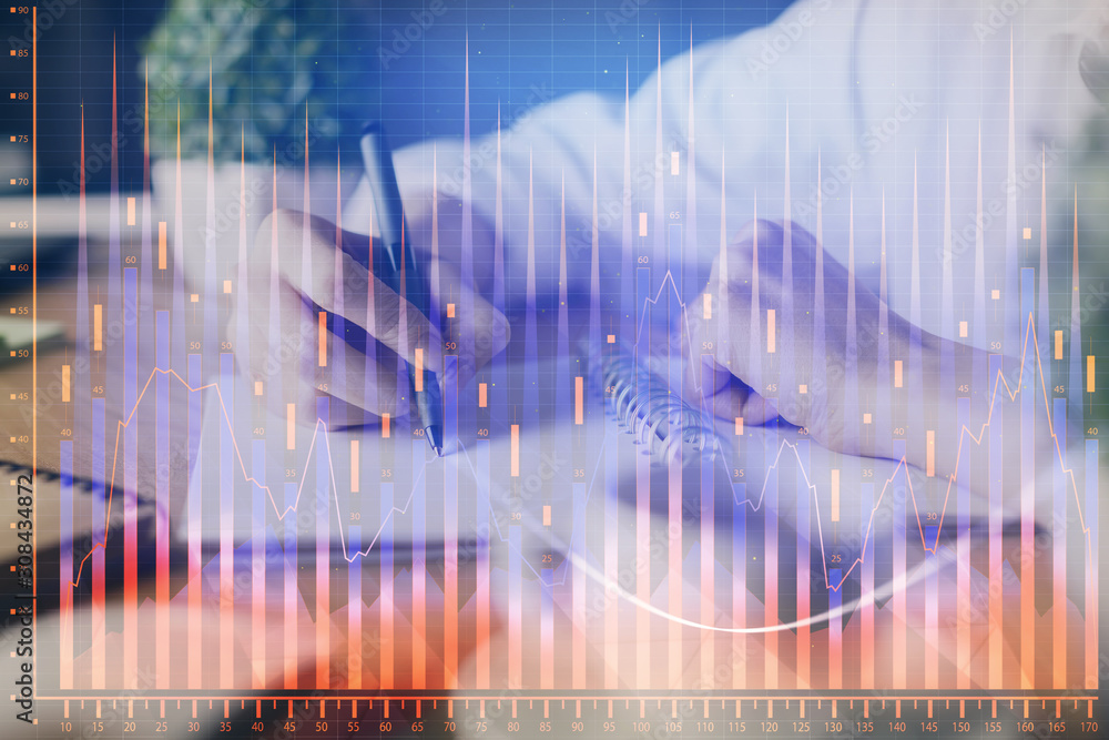 Financial forex graph displayed on hands taking notes background. Concept of research. Multi exposure Financial forex graph displayed on hands taking notes background. Concept of research. Multi exposure