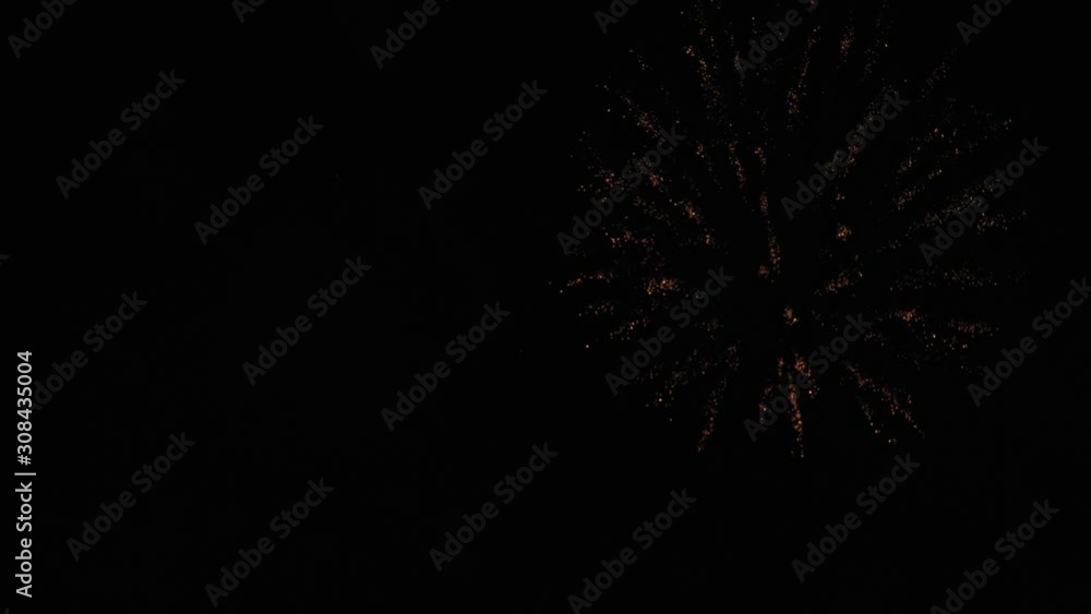 Golden big shiny fireworks with bokeh lights in the night sky. Glowing firework show. New Year's Eve fireworks celebration. Fireworks Festival. Golden big shiny fireworks with bokeh lights in the night sky. Glowing firework show. New Year's Eve fireworks celebration. Fireworks Festival.