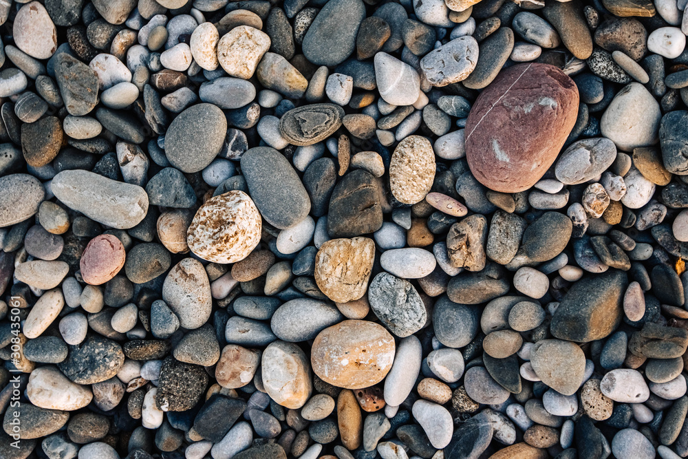 Gravel pattern of wet colored stones. Abstract nature pebbles background. Stone background. Sea peblles beach. Top view Gravel pattern of wet colored stones. Abstract nature pebbles background. Stone background. Sea peblles beach. Top view