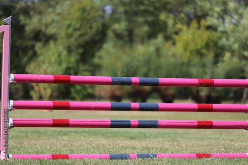 Image of show jumping poles on empty training field.
