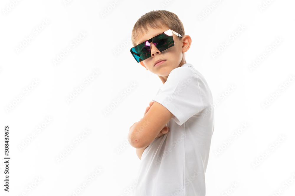 cute boy with bangs in a white t-shirt and glasses on a white background with copy space cute boy with bangs in a white t-shirt and glasses on a white background with copy space