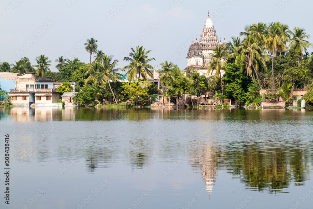 Fototapeta premium Shiva temple reflecting in a pond in Puthia village, Bangladesh