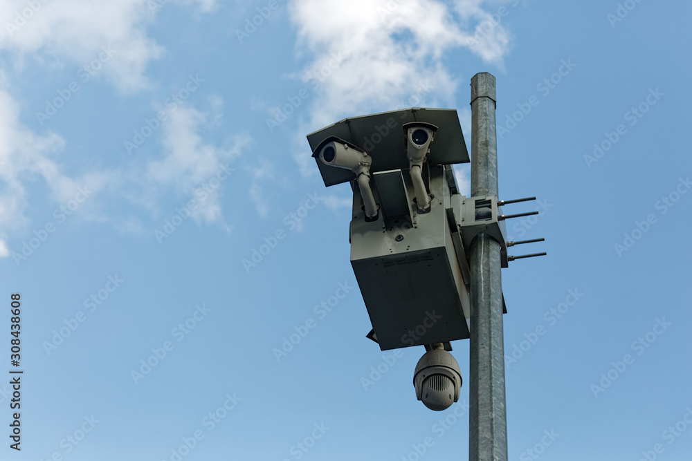 Digital Surveillance Cameras (EDS) attached to a pole in Istanbul Turkey. View from below and partial clouds on a clear blue sky in the background. Digital Surveillance Cameras (EDS) attached to a pole in Istanbul Turkey. View from below and partial clouds on a clear blue sky in the background.