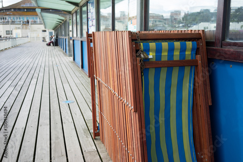 Stacked blue and yellow beach chairs on the Bornemouth pier in Dorset, England, Great Britain photo