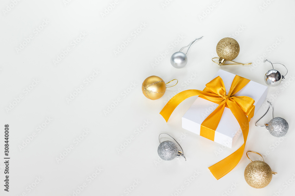 Paper gift box wrapped with yellow ribbon with Christmas decorations, isolated on white background. Presents and holidays concept.