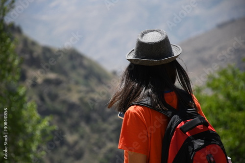 girl with a backpack on top of a mountain