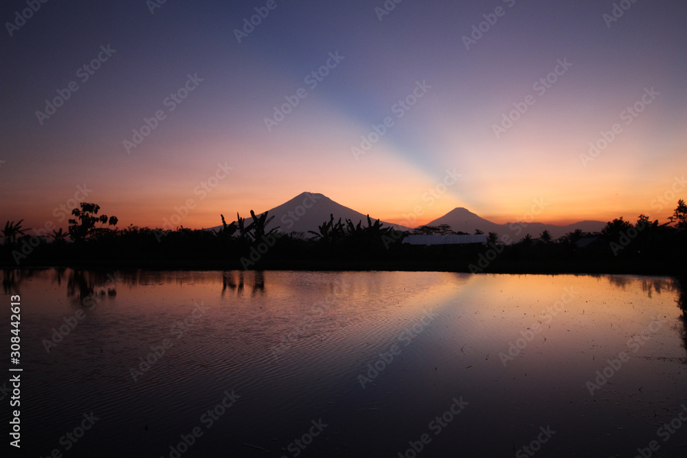 the beauty of the sunset with beauty reflection of mountains in Magelang, Central Java / Indonesia the beauty of the sunset with beauty reflection of mountains in Magelang, Central Java / Indonesia