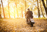 man on motorbike in autumn park