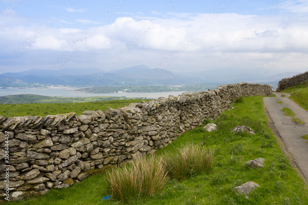 Old fashioned hand made stone wall  in Harlech Wales, UK.
