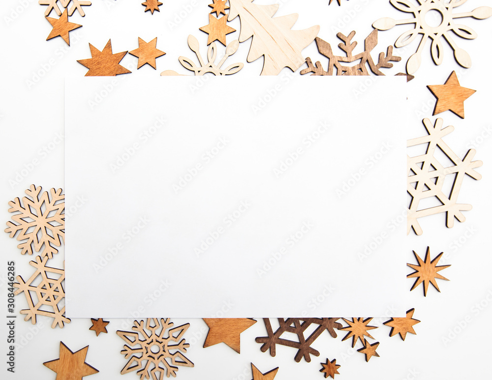 Fototapeta premium The beautiful christmas background with a lot of small wooden decorations on the white desk.