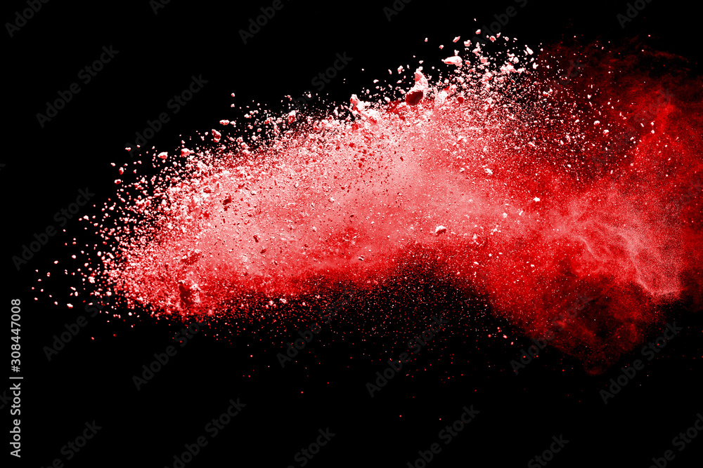 Red powder explosion on dark background. Colored cloud. Colorful dust explode. Paint Holi.