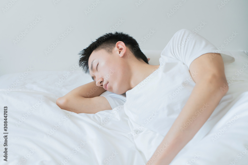 side view of bearded man sleeping on bed, lying on side side view of bearded man sleeping on bed, lying on side