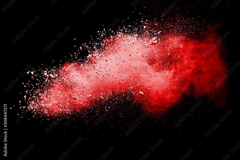 Red powder explosion on dark background. Colored cloud. Colorful dust explode. Paint Holi.