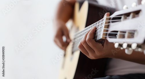Woman hands playing acoustic classic guitar the musician of jazz and easy listening style select focus shallow depth of field with copy space